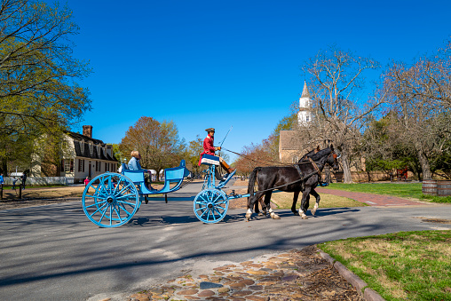 Williamsburg, Virginia, USA: 31st March 2021; Tourists on a horse drawn buggy in Williamsburg, Virginia.