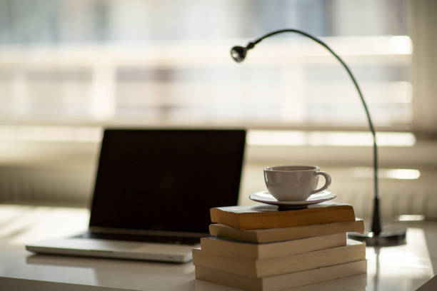 istock Cup of coffee and laptop on the table. 1397589910