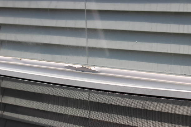 Damaged aluminum frame around the window screen due to hail storm in North Texas