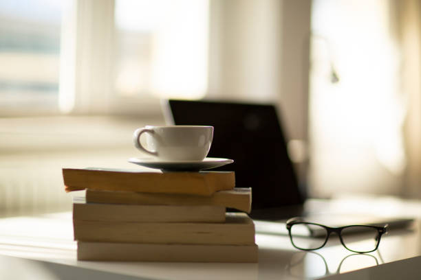 istock Cup of coffee and laptop on the table. 1397590558