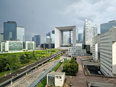 La Défense is a major business district at the City borders of Paris. The image shows the Skyline of this modern, pulsing District with the Grand Arche building (1989). Captured on a sunny day during spring season.
