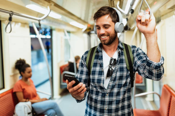 istock Diverse serious people in city commuting by metro line. Man using mobile app or e-banking on smart phone while riding 1397593027