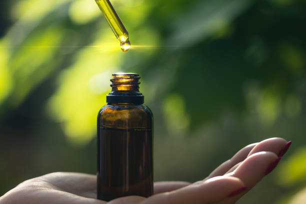 istock Dripping natural herbal oil into bottle on your hand. Copy space for text. 1397593078