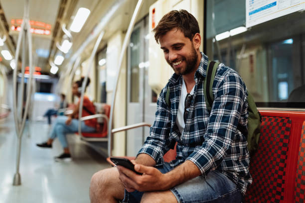istock Diverse serious people in city commuting by metro line. Handsome man using smart phone and smiling 1397593100