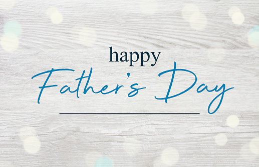 Happy Father's Day written on a  rustic wooden background.