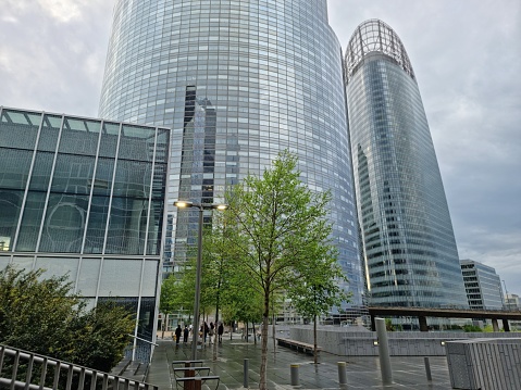 La Défense is a major business district at the City borders of Paris. The image shows several Skyscrapers on a day with cloudy sky. Captured during springtime.