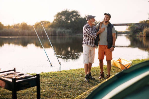 istock Happy man and his mature father having fun while camping in nature. 1397595372