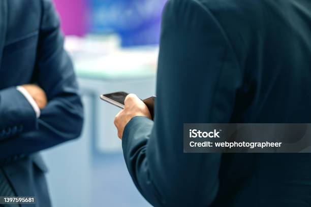 Businessman Taking Notes While Socializing Nikon Z7 Stock Photo - Download Image Now
