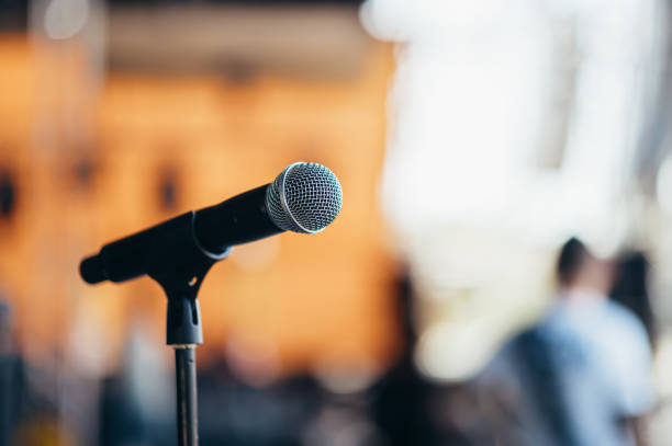 istock Microphone standing on a stage on a concert 1397597437
