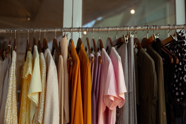 istock Hangers with different female clothes presenting at the retail store. 1397599640