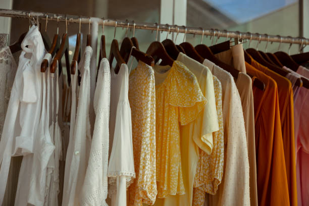 istock Hangers with different female clothes presenting at the retail store. 1397599672