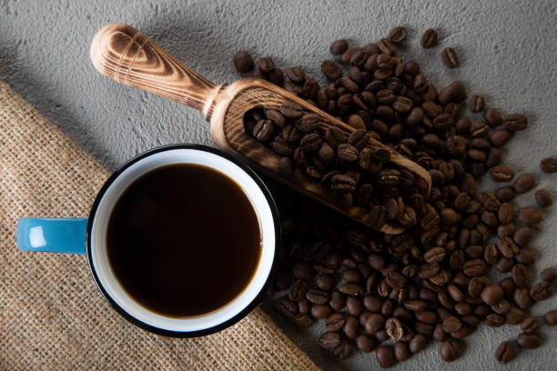 istock Blue cup of coffee with coffee beans on concrete background 1397600997