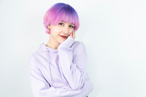 woman with pink and purple hair hair in front of a white background