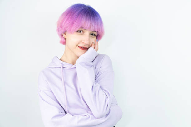 woman with pink and purple hair hair in front of a white background woman with pink and purple hair hair in front of a white background purple hair stock pictures, royalty-free photos & images