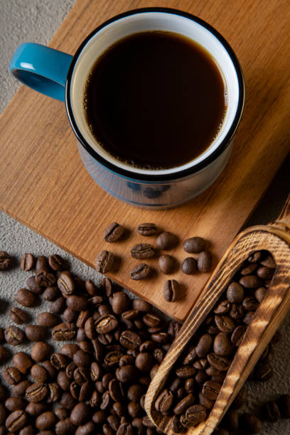 istock Blue cup of coffee with coffee beans on concrete background 1397601940