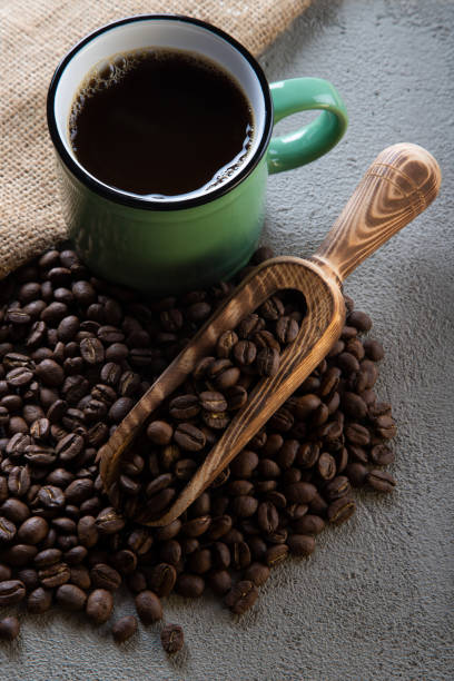 istock Cup of coffee with coffee beans on concrete background 1397602079