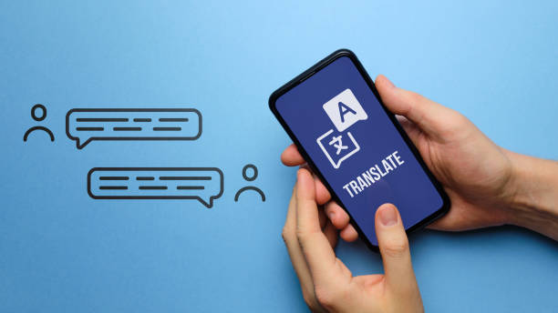 Translate concept. Smartphone application. Hands hold the phone.