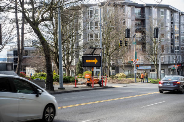 angled view of a road sign pointing the direction of the climate change arena parking garage - keyarena imagens e fotografias de stock