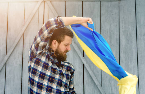 istock Man holding State Flag of Ukraine 1397603224