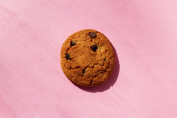istock One oatmeal cookie with raisins on a pink background 1397604847