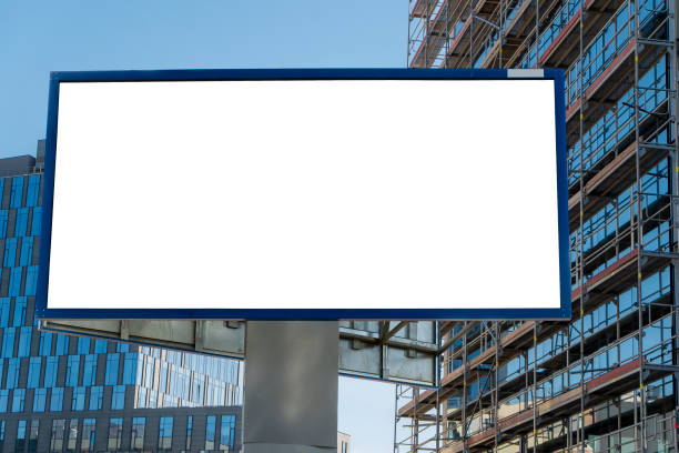 istock Advertising billboard mock-up next to modern office building with glass facade under construction 1397605480