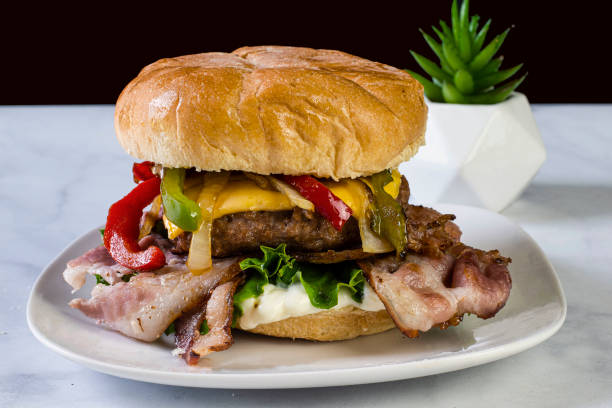 istock bacon cheese burger  top with onions and peppers 1397605670
