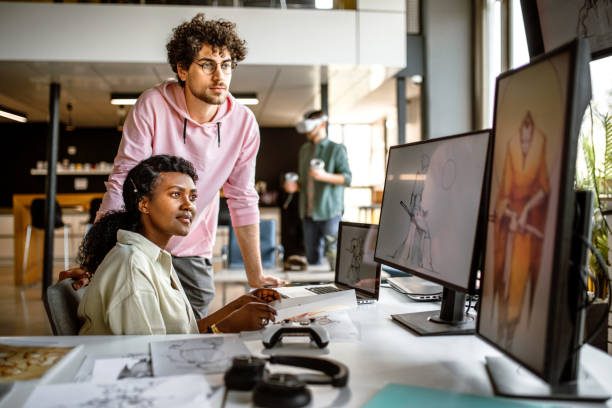 istock Group of young designer working in the office using laptop 1397606465