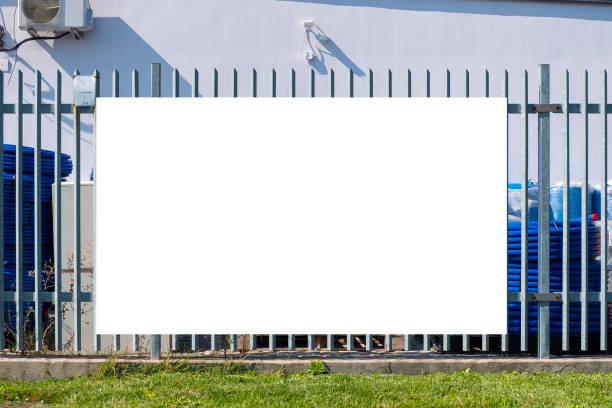 istock Blank white banner mockup on the fence of construction warehouse 1397608403