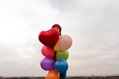 Young asian woman with colored balloons
