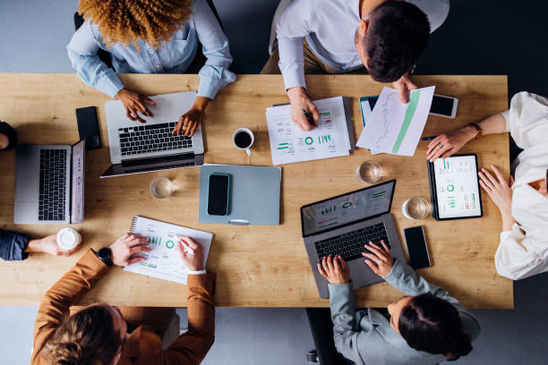 istock Group of Businesspeople Analyzing Business Graphs and Documents Together 1397610318