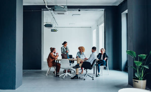 group of businesspeople having a meeting at their modern company - modern office stockfoto's en -beelden