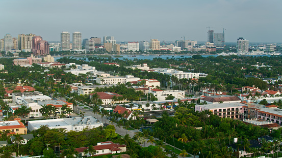 Aerial shot of Palm Beach, Florida on a hazy morning, looking across the island to the West Palm Beach skyline.  \n\nAuthorization was obtained from the FAA for this operation in restricted airspace.