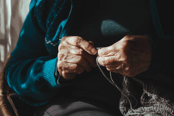 istock hands of a grandmother weaving. front view. 1397616613