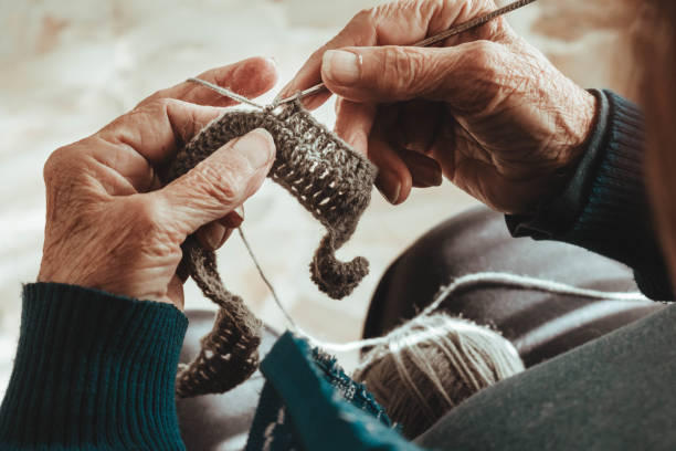 istock hands knitting grandmother. top view. wool 1397616620