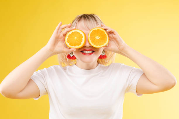 istock Cheerful young blonde posing with fresh oranges 1397621940