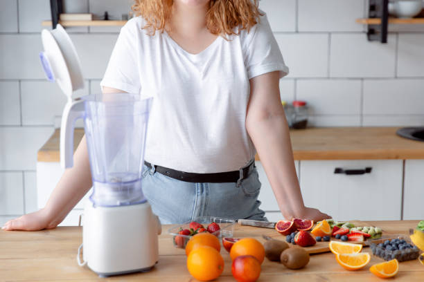 istock Woman preparing smoothie at home kitchen. 1397622866