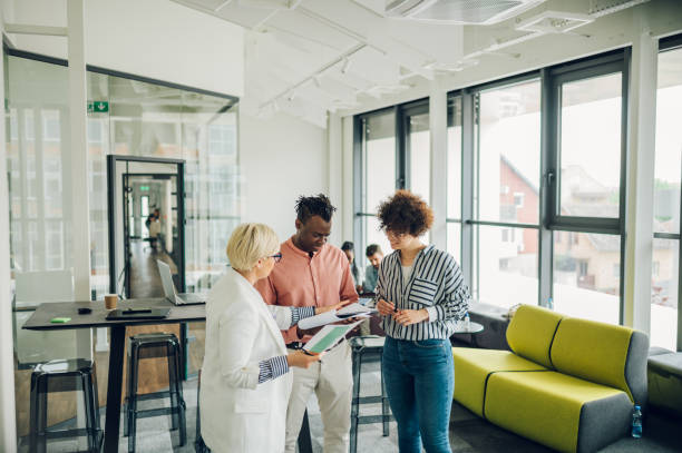 istock Multiracial business colleagues discussing about documents in the office 1397623044