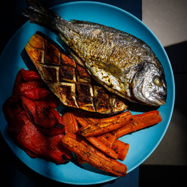 Grilled paprika pepper, carrot, eggplant, and Dorado fish.