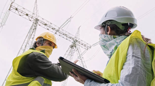 istock High voltage engineers working on the field in COVID-19. Teamwork. 1397623384