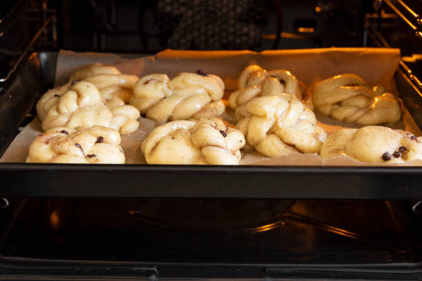 istock Homemade buns before baking. Cooking process - put the baking sheet in the oven. Selective focus. 1397624131