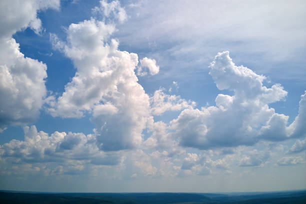 istock Bright landscape of white puffy cumulus clouds on blue clear sky 1397628977