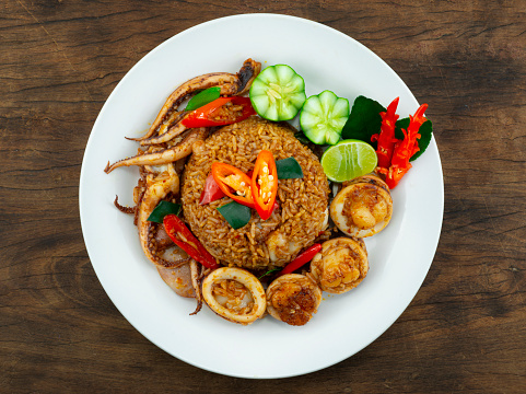 Fried Rice with Spicy Tomyum Sauce and Squids dish Thaifood fusion Style decoration carving vegetables topview