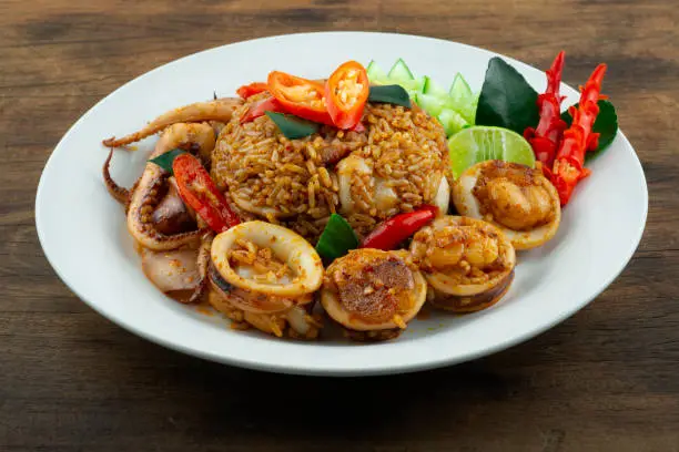 Fried Rice with Spicy Tomyum Sauce and Squids dish Thaifood fusion Style decoration carving vegetablessideview