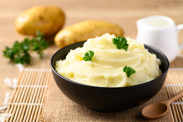 istock Mashed potato with parsley in black bowl 1397633936