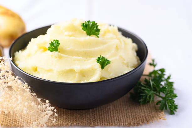 istock Mashed potato with parsley in black bowl 1397633951