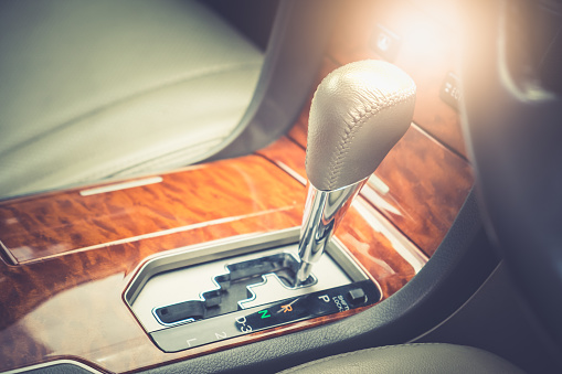 Automatic gear shift stick inside modern car.