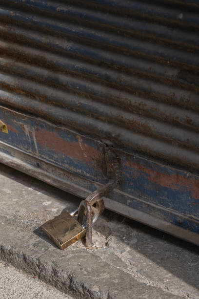 istock Closed shop shutter and padlock. Economic crises and bankruptcies. 1397638264