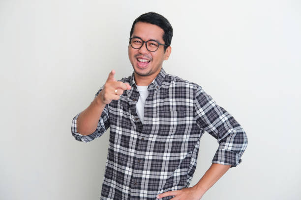 istock Adult Asian man showing excited expression while pointing finger forward 1397640400