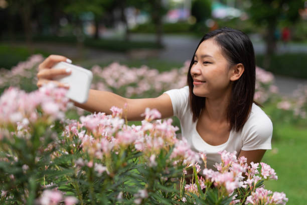 istock Young asian lady chill relaxing and selfie in a park 1397641307