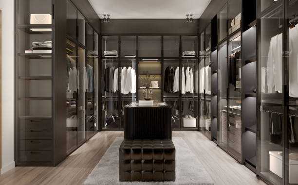 istock Modern black wardrobe and lighting with clothes hanging on rail in walk in closet design interior. 3D illustration 1397641453